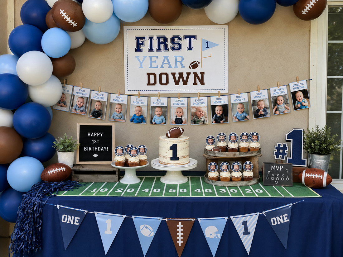 Blue white and brown First Year Down football first birthday dessert table with balloons cake and twelve month baby photo banner
