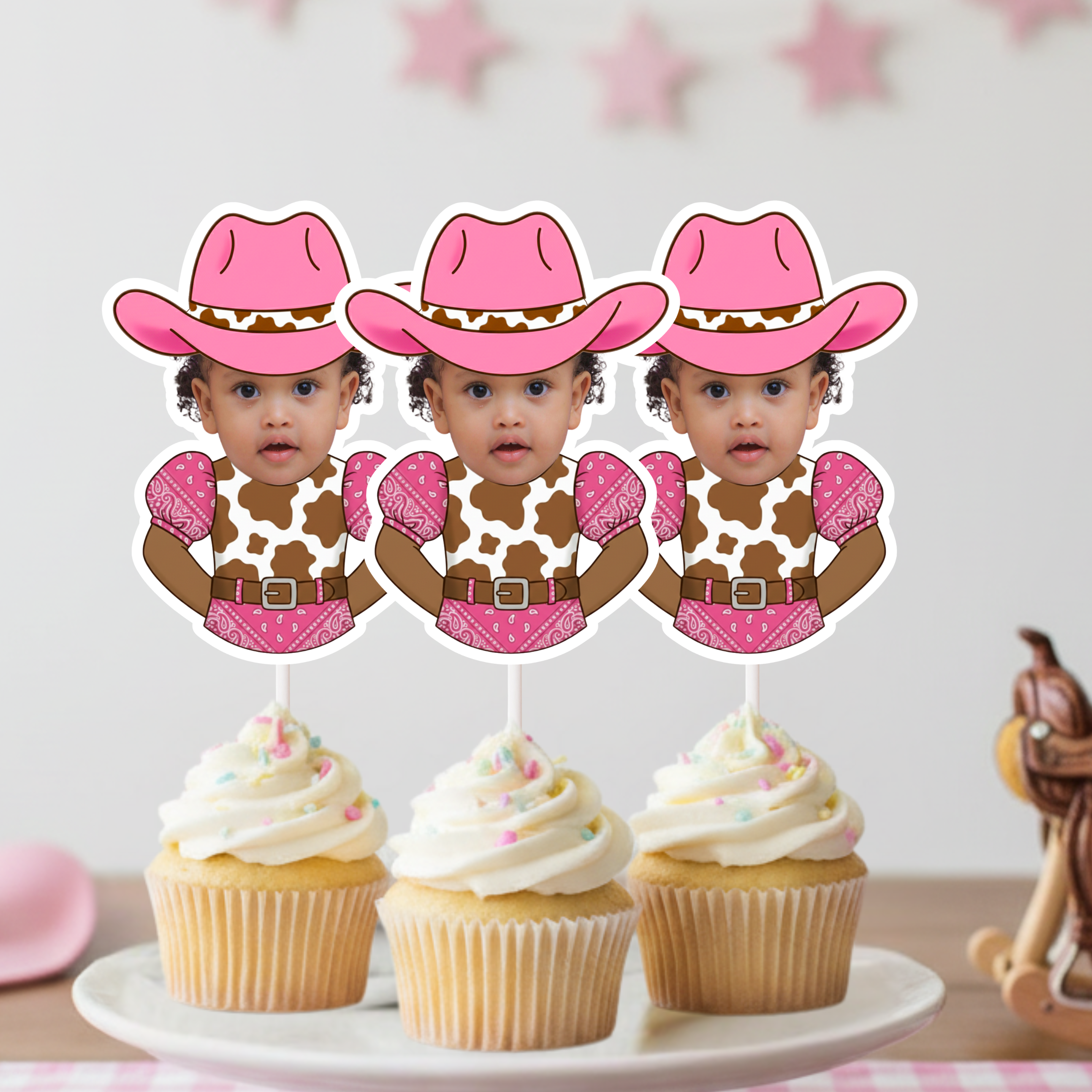Personalized baby girl cowgirl cupcake toppers featuring a custom infant photo dressed in a pink bandana western outfit with a pink cowboy hat, displayed on frosted cupcakes for a “My First Rodeo” celebration. These pink western cupcake decorations are perfect for first birthday parties, cowgirl themed baby birthdays, rustic rodeo baby showers, country girl milestone celebrations, and western smash cake photo sessions. Designed as high quality custom photo cupcake picks, these cowgirl birthday decorations e