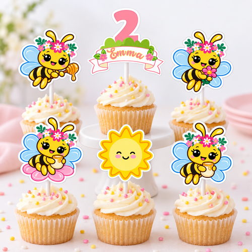 Personalized bee garden cupcake toppers on cupcakes with Emma age two topper, smiling sun and floral honey bee designs for a birthday dessert table.