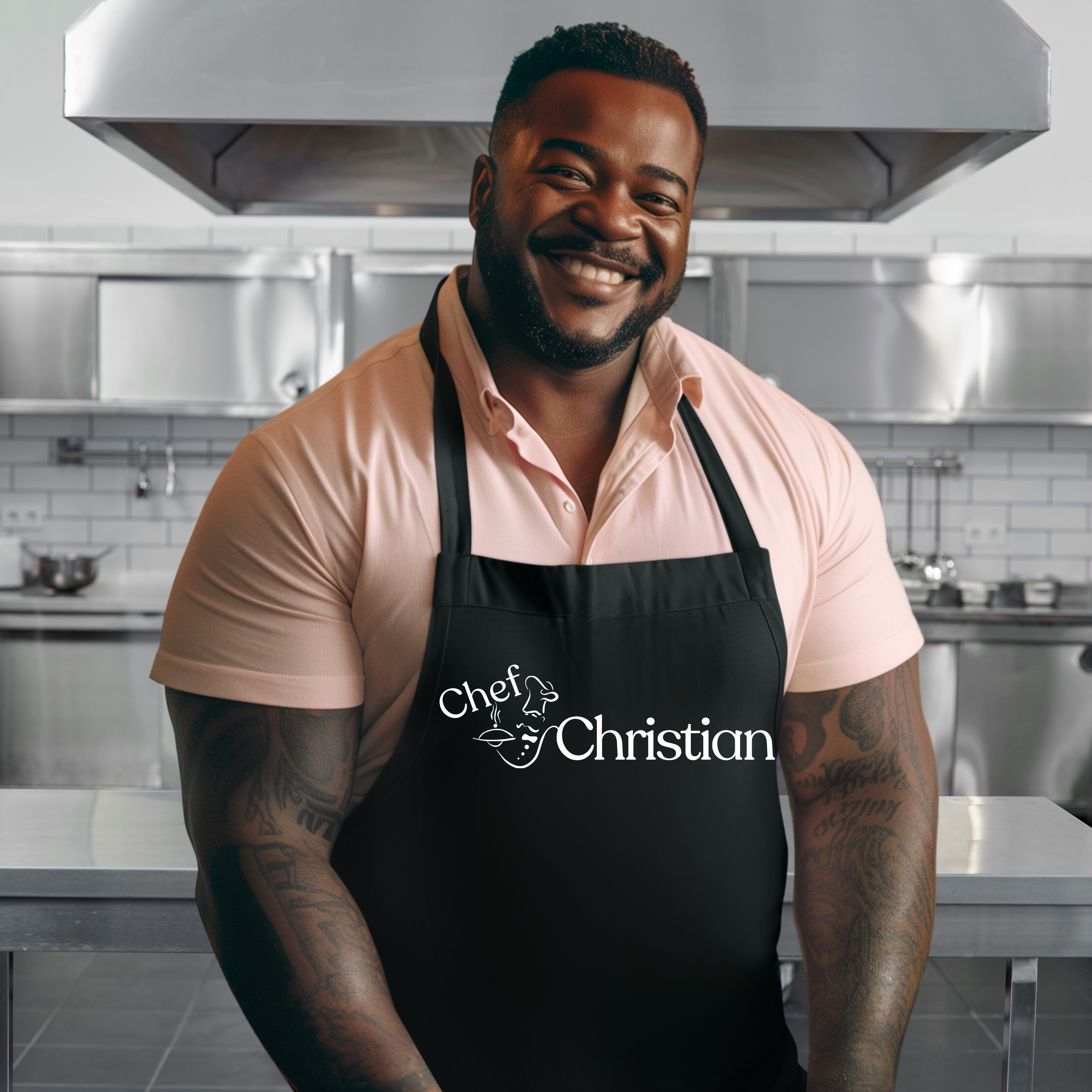 Man wearing a black apron with 'Chef Christian' text in a kitchen setting