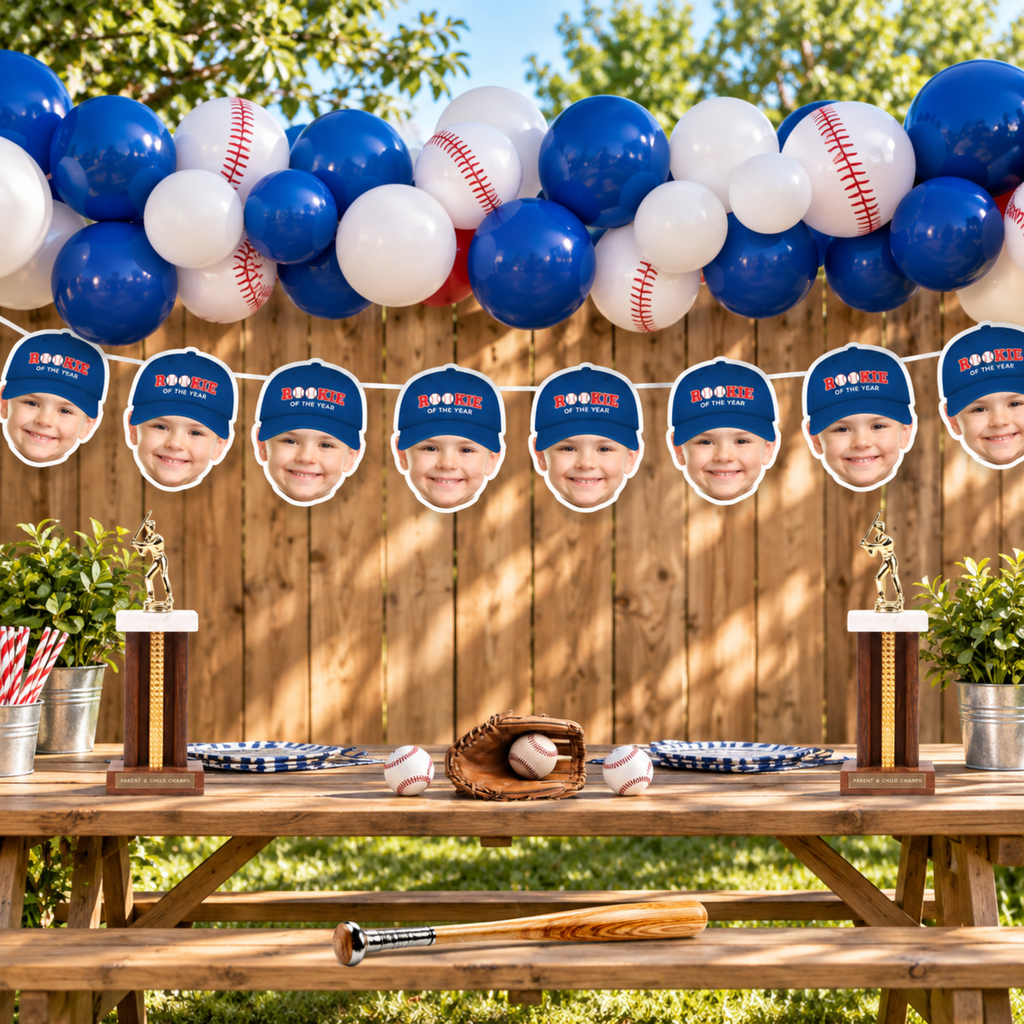 Blue Rookie of the Year personalized photo banner displayed at an outdoor baseball birthday party with blue white balloons and baseball decorations