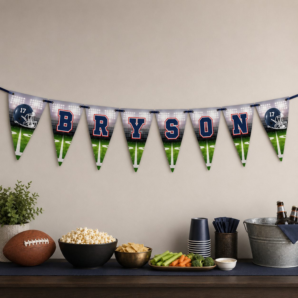 Navy and red football party banner personalized with Bryson displayed above a game-day snack and drink table.