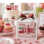 Cherry Sweet One first birthday party setup featuring personalized handmade favor box, layered cardstock cherry decorations, birthday cake, cupcakes, balloons, and coordinated girls first birthday celebration decor.