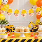 Construction-themed party decoration set featuring a banner of custom photo cutouts wearing yellow hard hats, yellow toy dump trucks and excavator, orange traffic cones, and yellow and black striped table accents.