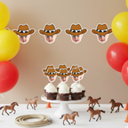 Western birthday setup featuring personalized cowboy baby face banner strung above matching cupcake toppers on cake stand, styled with toy horses, rope, and red and yellow balloons. Ideal for cowboy first birthday parties, wild west celebrations, and rodeo themed baby milestone events. Custom photo party decorations for cohesive western décor.