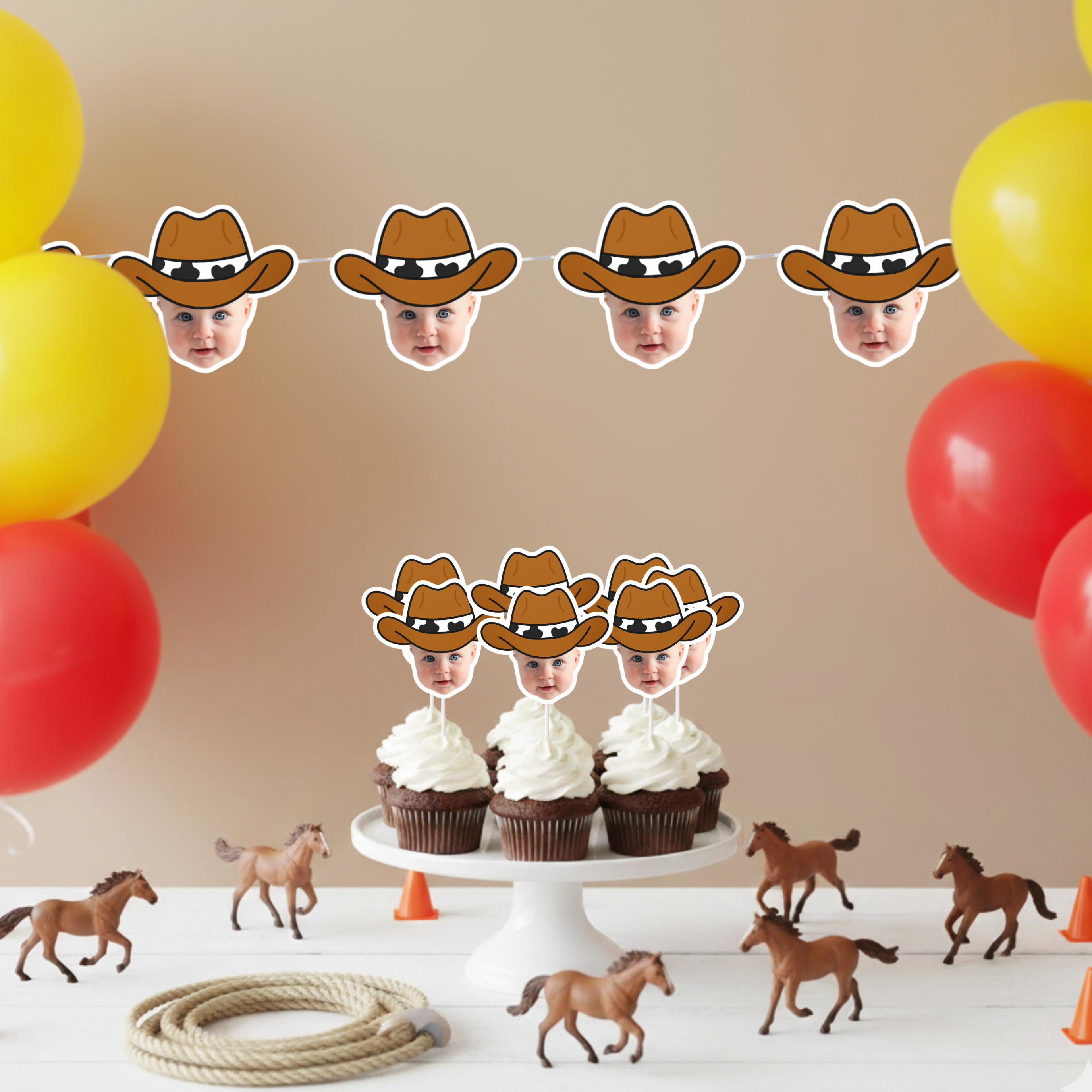 Western birthday setup featuring personalized cowboy baby face banner strung above matching cupcake toppers on cake stand, styled with toy horses, rope, and red and yellow balloons. Ideal for cowboy first birthday parties, wild west celebrations, and rodeo themed baby milestone events. Custom photo party decorations for cohesive western décor.