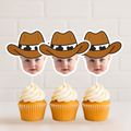 Set of three personalized cowboy baby face cupcake toppers displayed on vanilla cupcakes with white frosting against white brick background. Perfect for cowboy first birthday celebrations, wild west baby parties, and rodeo themed dessert tables. Custom child photo cupcake picks featuring brown cowboy hat design.