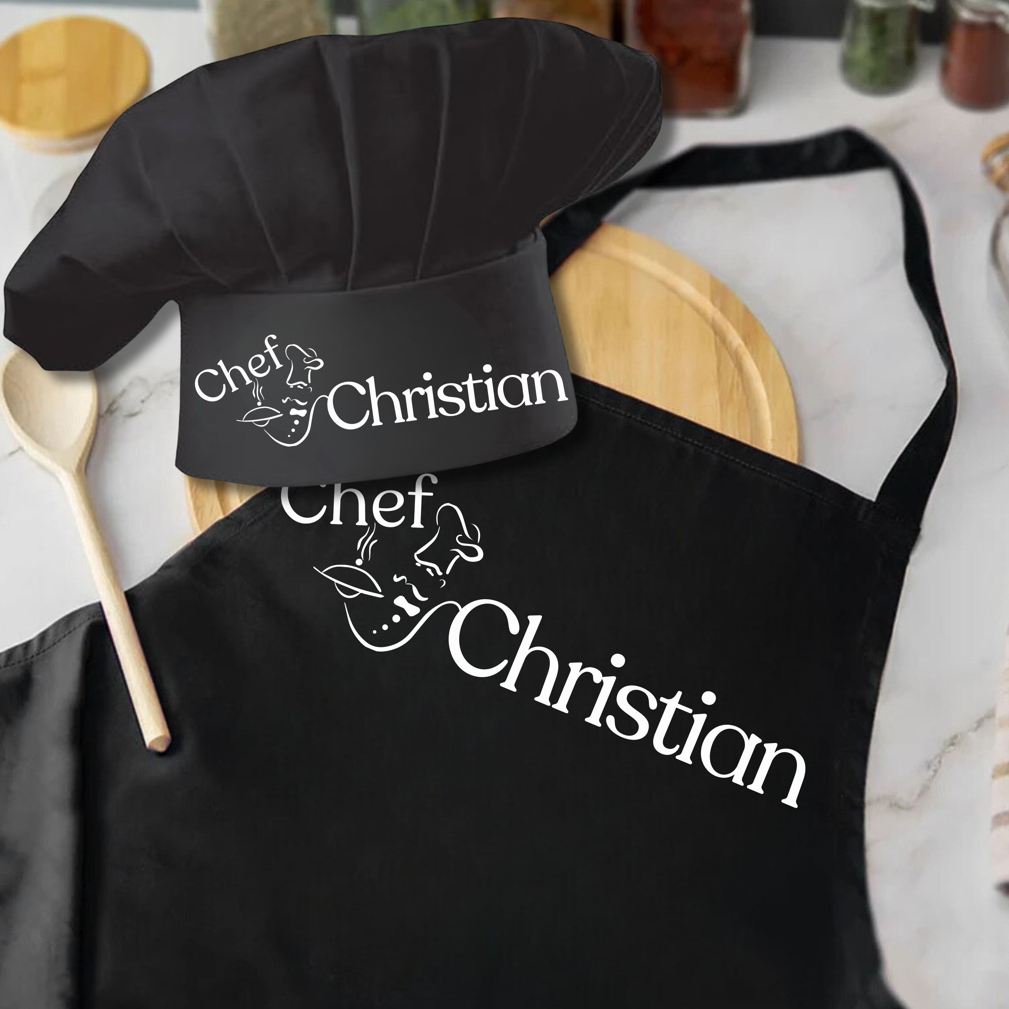Black chef hat and apron with 'Chef Christian' branding on a kitchen counter.