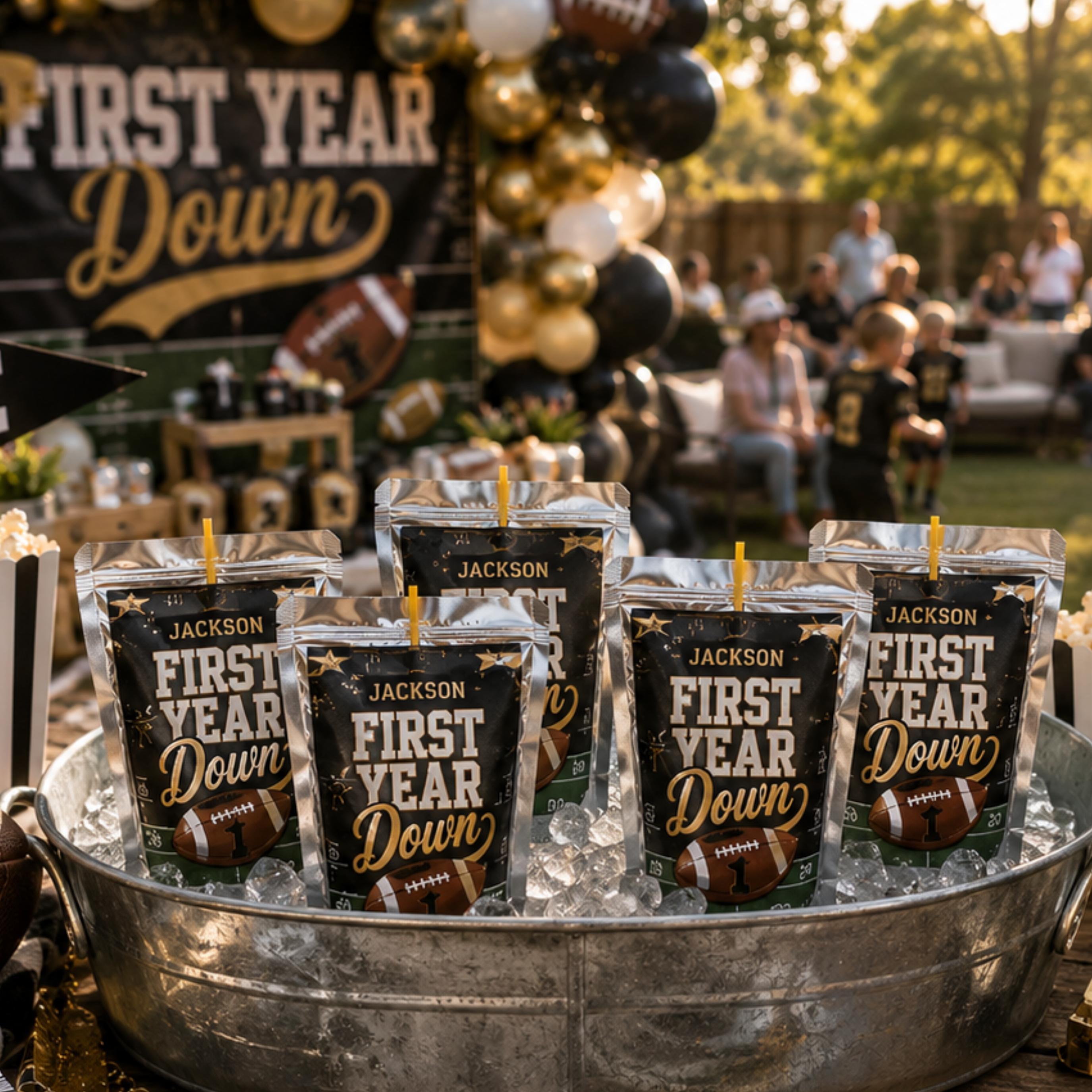 Custom football themed first birthday juice pouch labels personalized for a First Year Down birthday party with black gold football decorations and custom party favors.