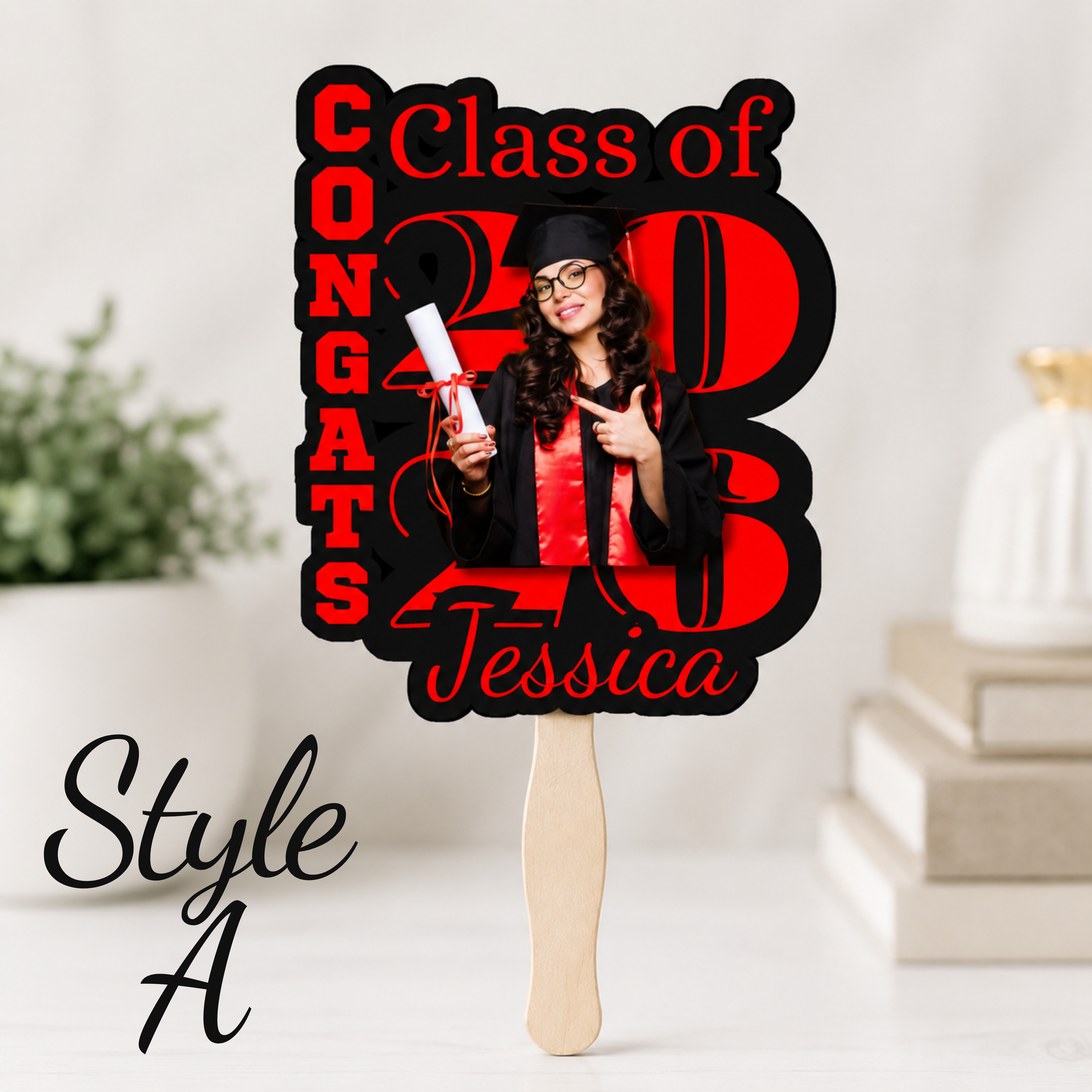 Red and black personalized graduation fan featuring a senior photo, Class of 2026 text, and custom graduate name. Boutique style graduation cheering fan perfect for graduation ceremonies, senior night celebrations, and graduation party decorations. Graduation-themed cutout with 'Congrats Class of 2023 Jessica' text and a person holding a diploma.