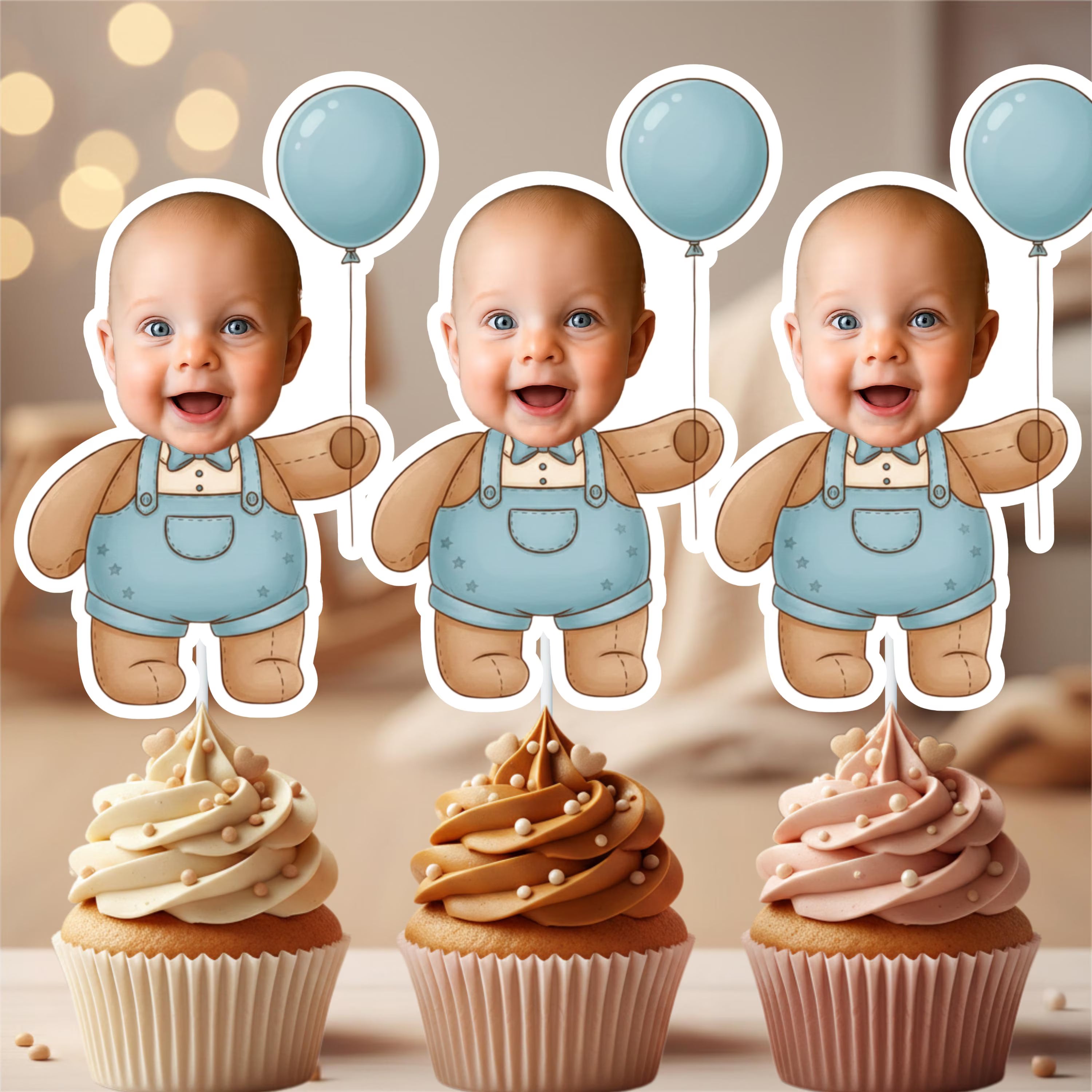Three identical baby figurines in blue overalls with balloons above cupcakes on a blurred background