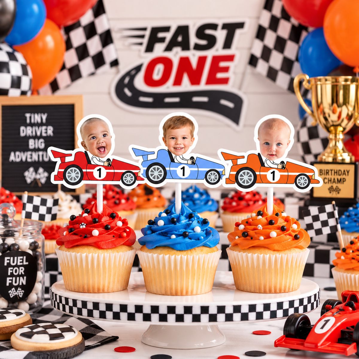 Fast One personalized race car photo cupcake toppers in red blue and orange displayed at a first birthday racing party
