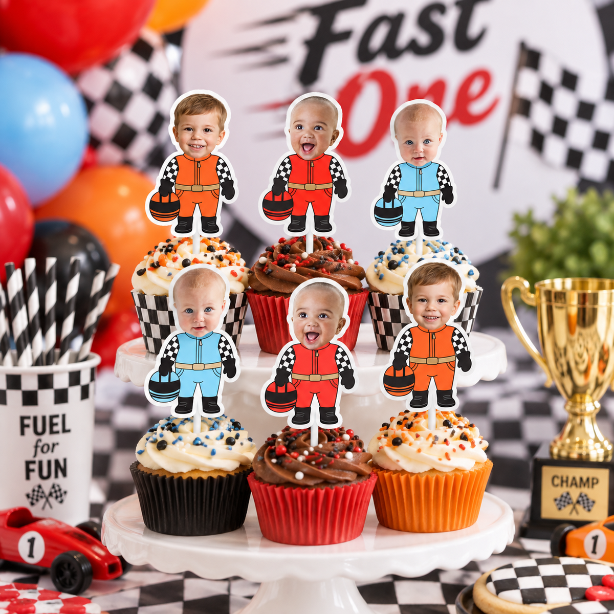 Fast One race car birthday cupcake display with personalized child photo driver toppers in red blue and orange for a first birthday party
