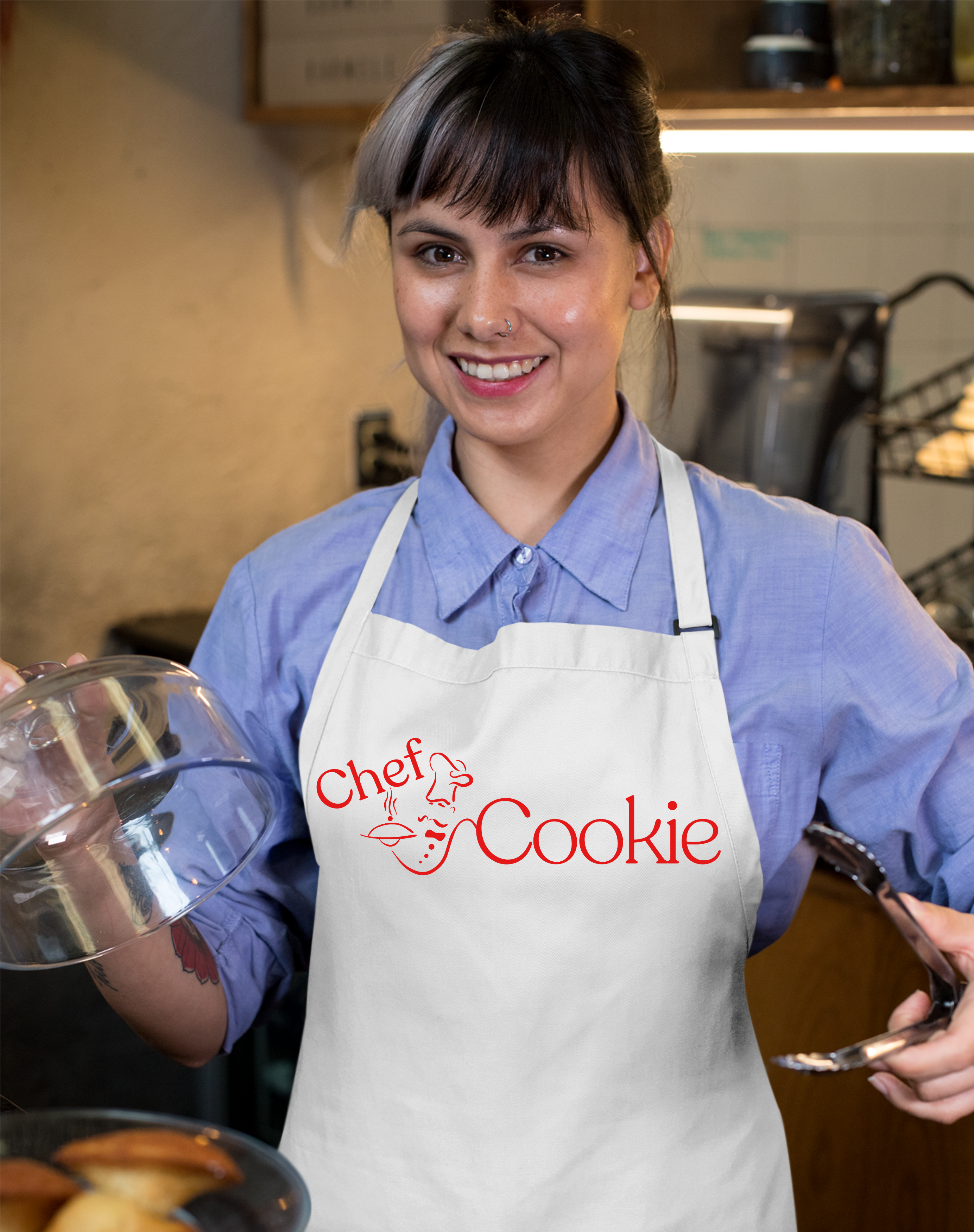 Woman wearing a 'Chef Cookie' apron in a kitchen setting