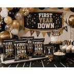 Custom football themed first birthday party chip bags featuring black gold football decorations for first year down birthday celebration