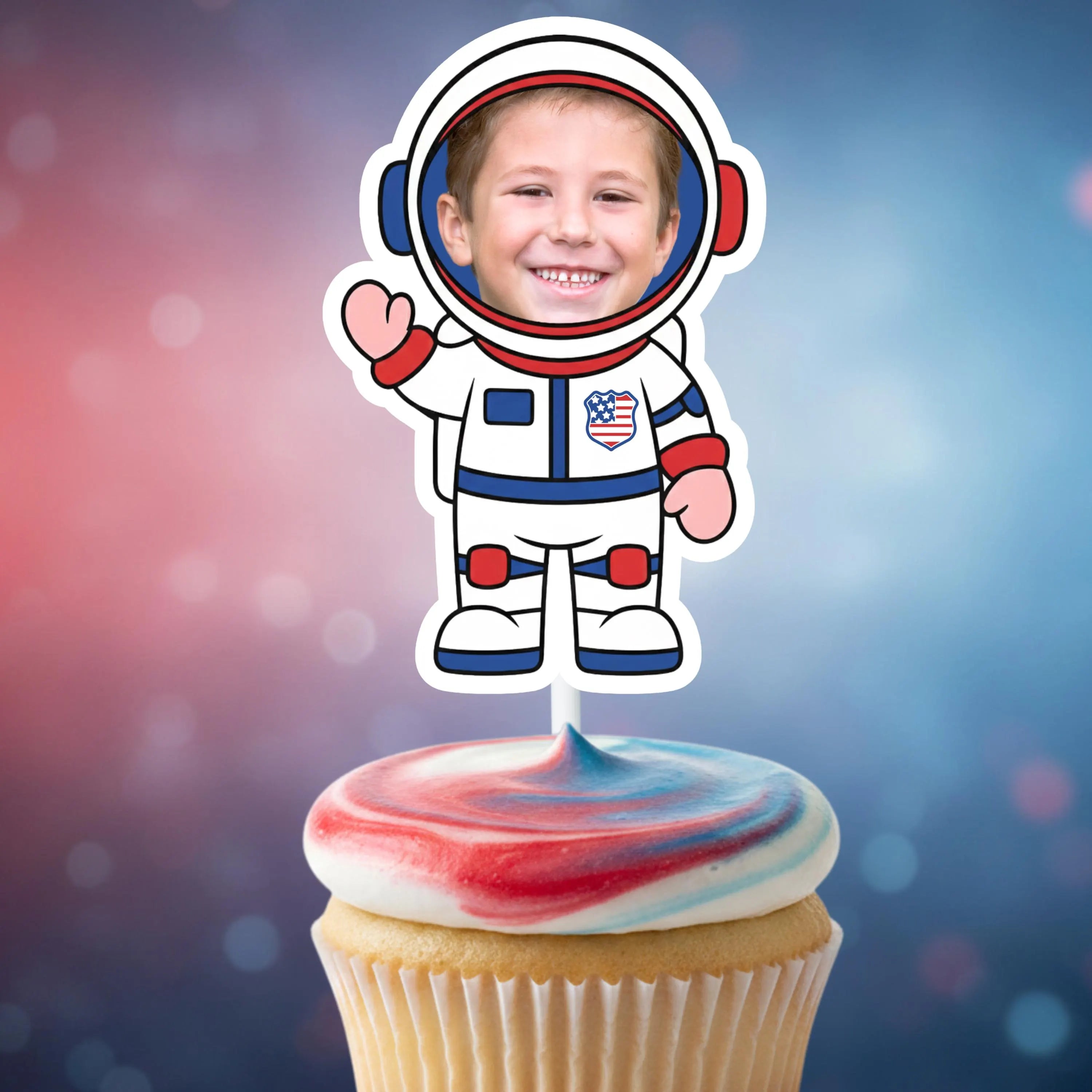 Cupcake with red, white, and blue frosting topped with an astronaut cupcake topper against a colorful background.