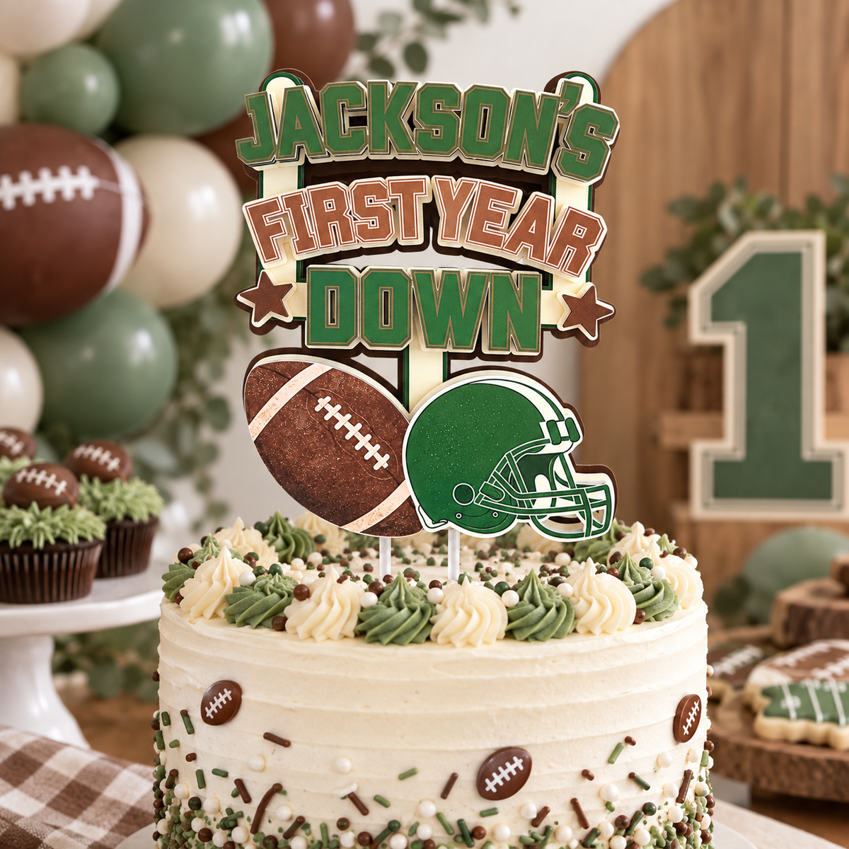 Personalized First Year Down football birthday cake topper displayed on a decorated first birthday cake with green brown and cream party decor