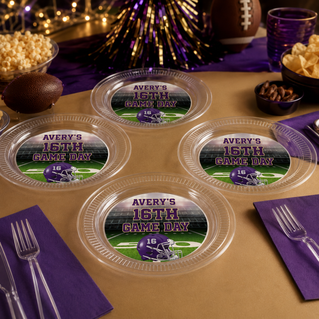 Purple and gold personalized clear football plates for a sixteenth birthday game day table setting