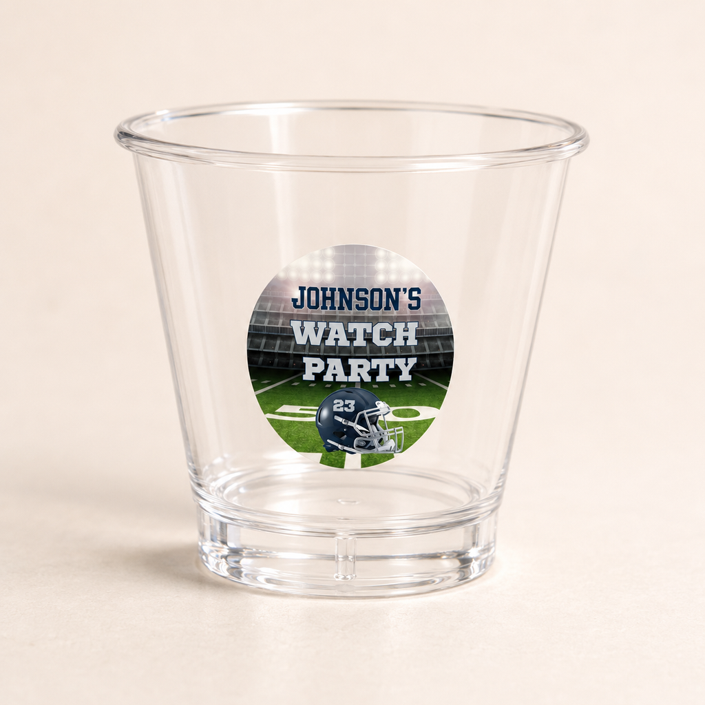 Personalized 2 oz clear plastic football shot glass with circular game day sticker and custom helmet number