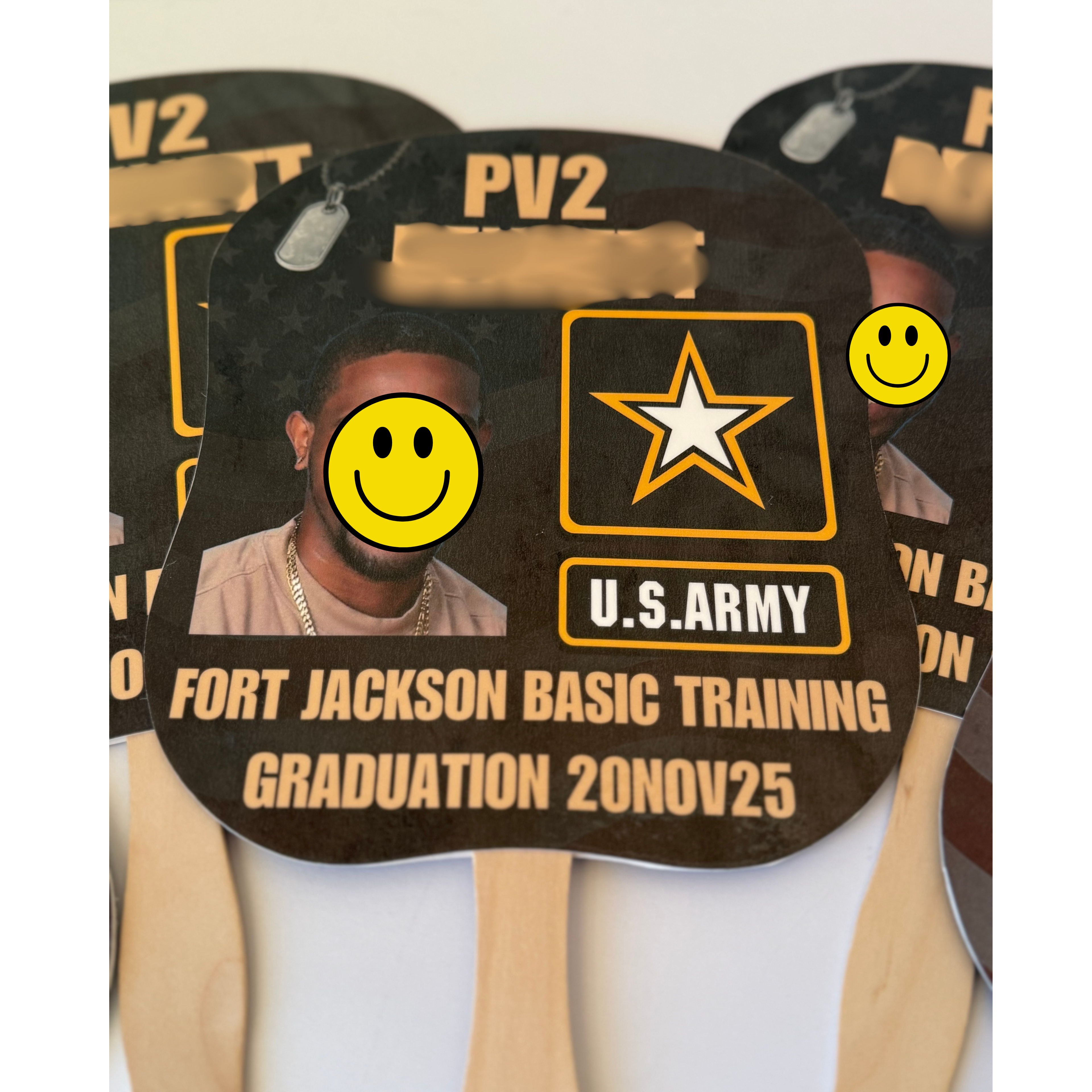 U.S. Army Fort Jackson Basic Training graduation card with a person's face blurred and smiley faces. Custom Fort Jackson basic training graduation fan with personalized Army recruit photo, graduation date, and military ceremony keepsake design.