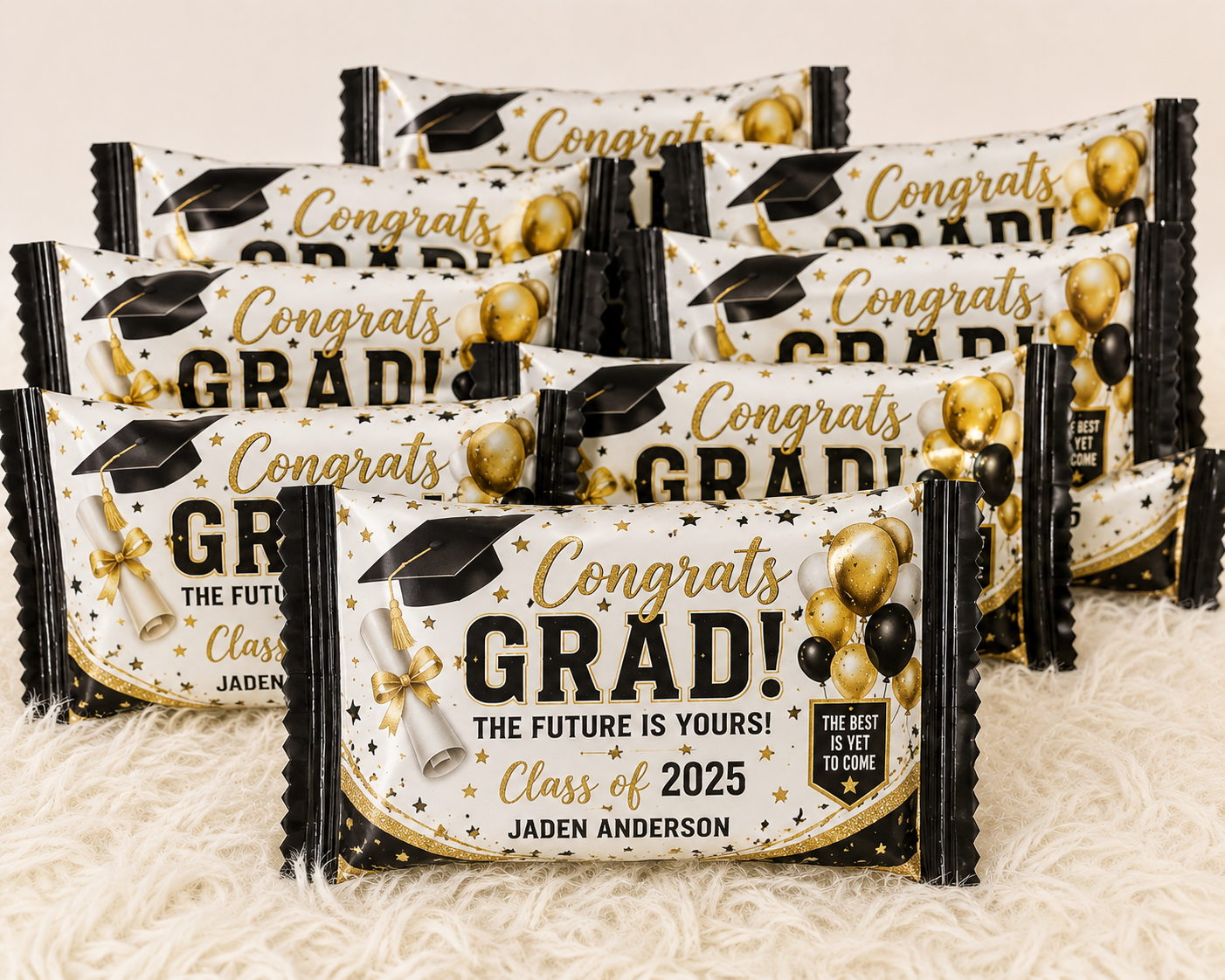 Custom graduation Rice Krispie Treat wrappers featuring black and gold graduation decorations, personalized with the graduate's name for memorable graduation party favors.