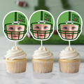 Three green football helmet First Year Down personalized photo cupcake toppers displayed on vanilla cupcakes with smooth white buttercream frosting. Sports themed football 1st birthday party decorations styled for a baby boy dessert table with custom team color helmet design.