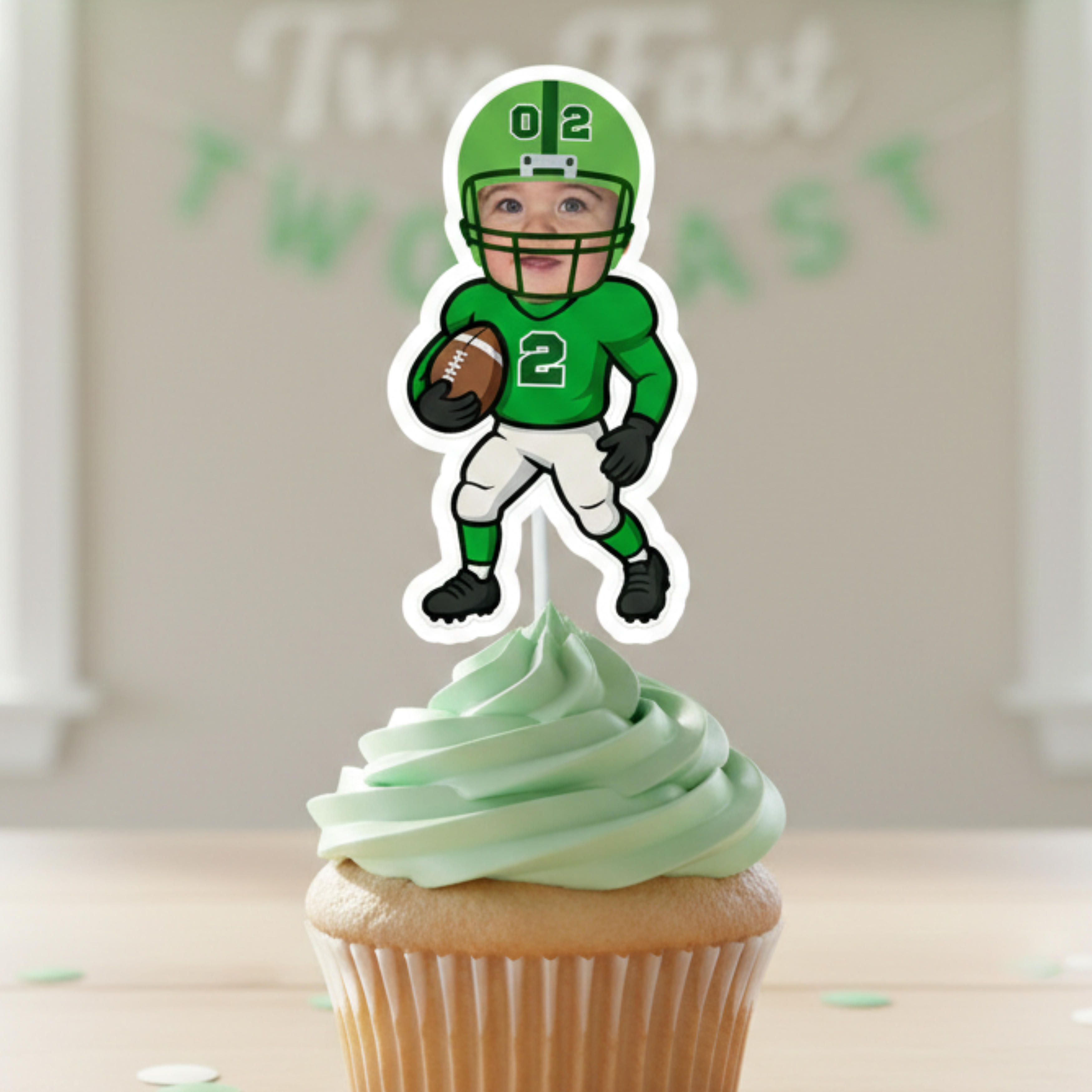 Three personalized football cupcake toppers featuring a custom photo face and green jersey with the number 2, displayed on vanilla cupcakes with green frosting for a toddler football birthday party. These age 2 sports themed dessert decorations are perfect for a second birthday celebration, game day party theme, or youth football inspired baby milestone event. Custom face sports party supplies designed for little athletes turning two.