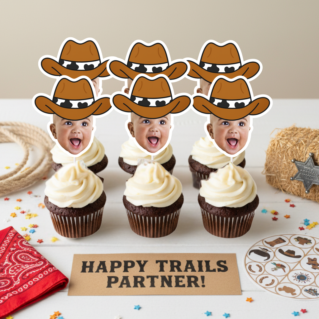 Cowboy themed cupcake display featuring personalized baby face toppers wearing brown cowboy hats arranged above “Happy Trails Partner” sign with bandana, rope, and hay bale accents. Ideal for wild west birthday parties, rodeo baby showers, and cowboy first birthday celebrations. Custom photo cupcake decorations for western dessert tables.