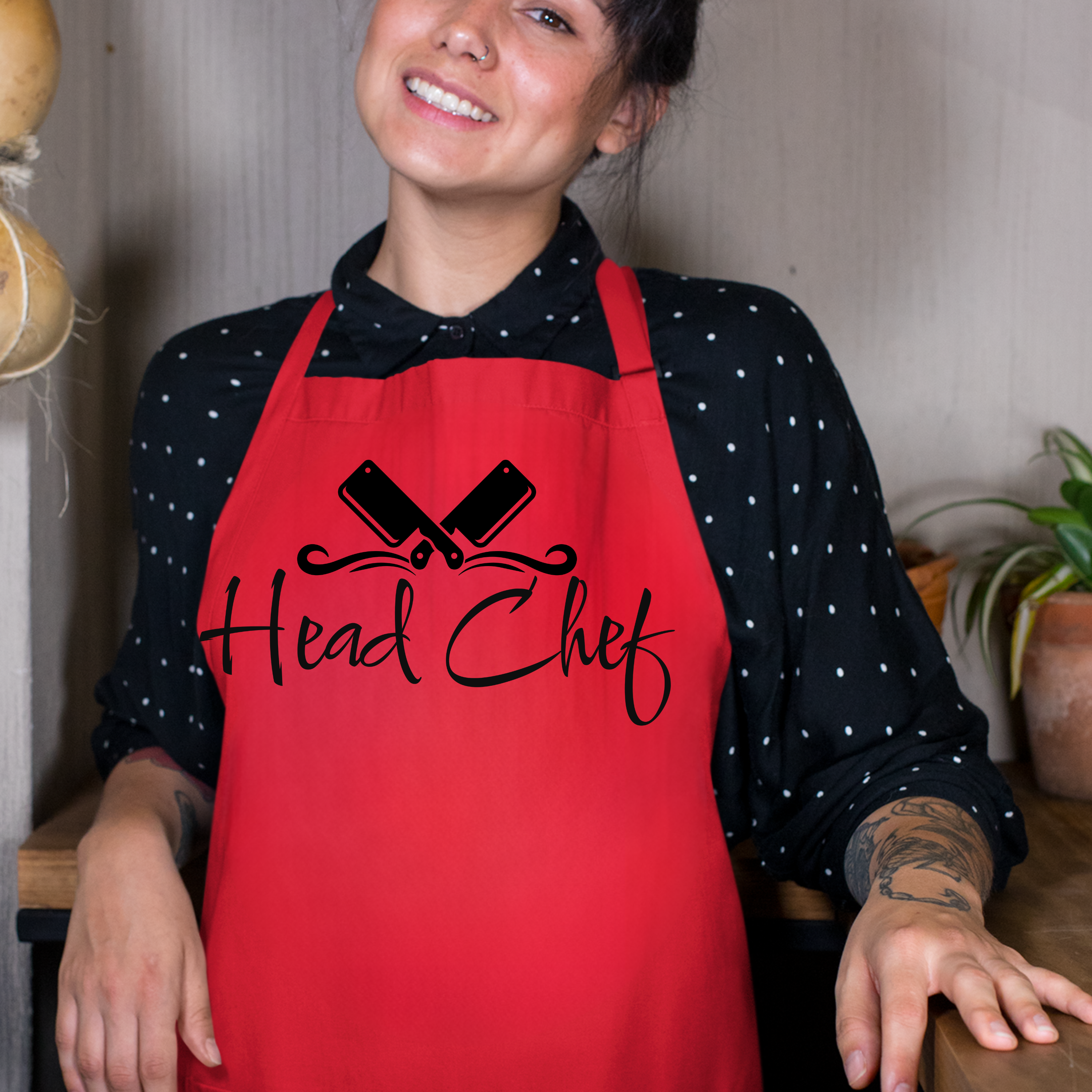 Person wearing a red 'Head Chef' apron in a kitchen setting