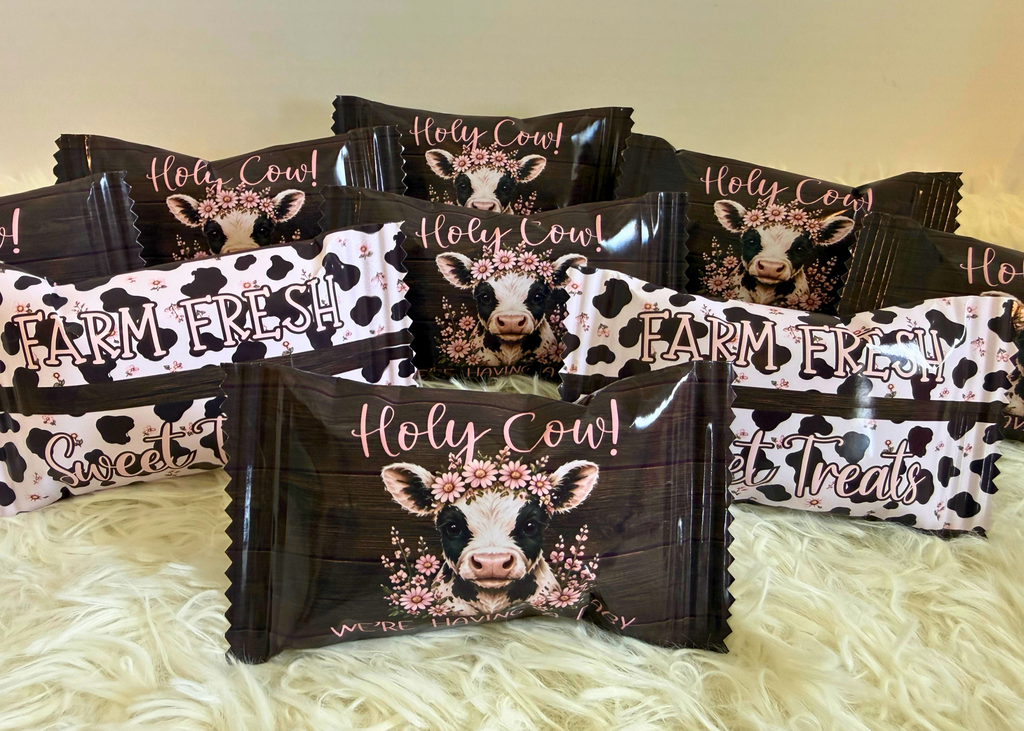 Custom Holy Cow first birthday Rice Krispie Treat wrappers featuring a floral Highland cow, rustic wood details, and cow print accents for a charming farm-themed celebration.