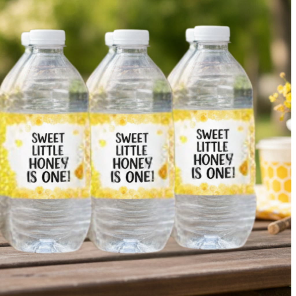 Three water bottles with personalized labels on a wooden surface outdoors.