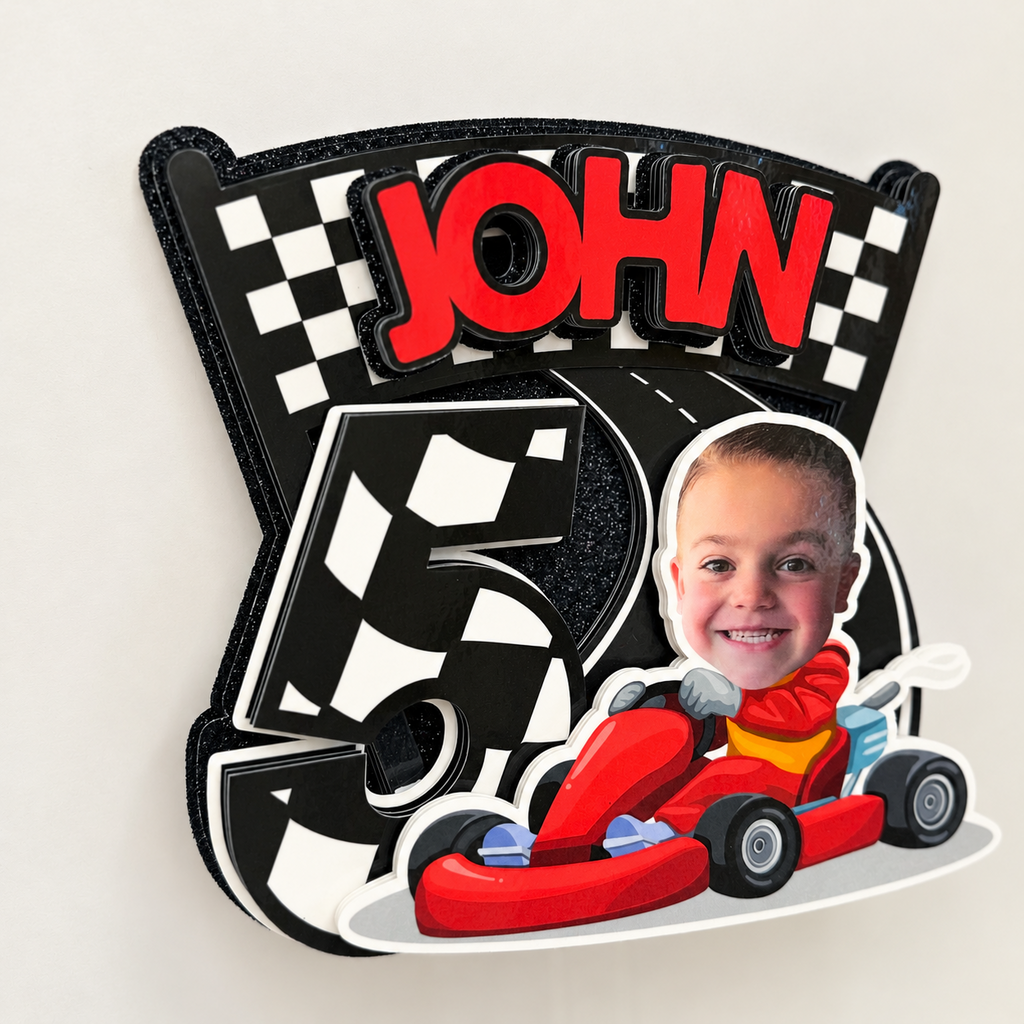 Detailed angled view of laminated layered racing cake topper with personalized name age child photo and checkered race track design