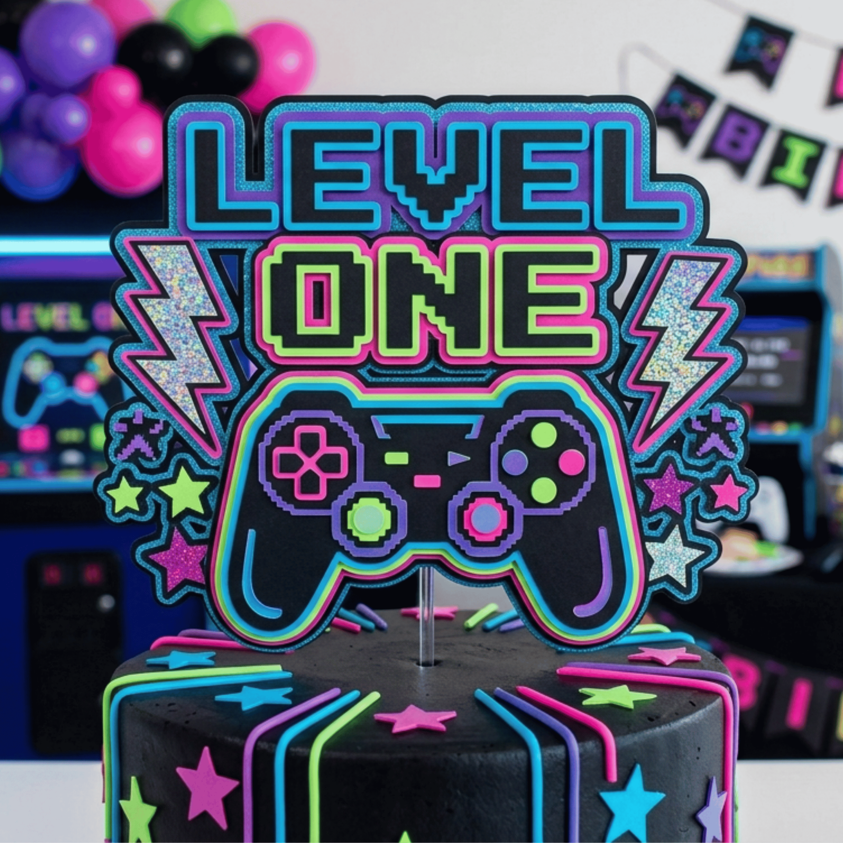 Video game themed first birthday cake topper featuring neon controller pixel style lettering stars and bright layered cardstock handmade gaming birthday decoration