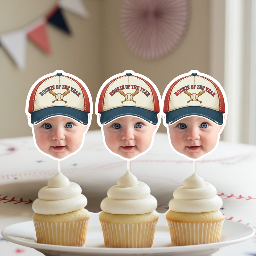 Little Slugger baseball first birthday cupcake toppers featuring personalized baby face cutouts with baseball hat design on vanilla cupcakes, styled for a baseball themed first birthday party and rookie of the year celebration.