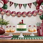 Personalized First Year Down football photo banner featuring child faces in maroon football helmets displayed above a football first birthday cake and dessert table