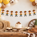Personalized My First Rodeo cowboy photo banner displayed on a white wood wall with yellow and cream balloons hay bales rope cowboy hat and western birthday decorations
