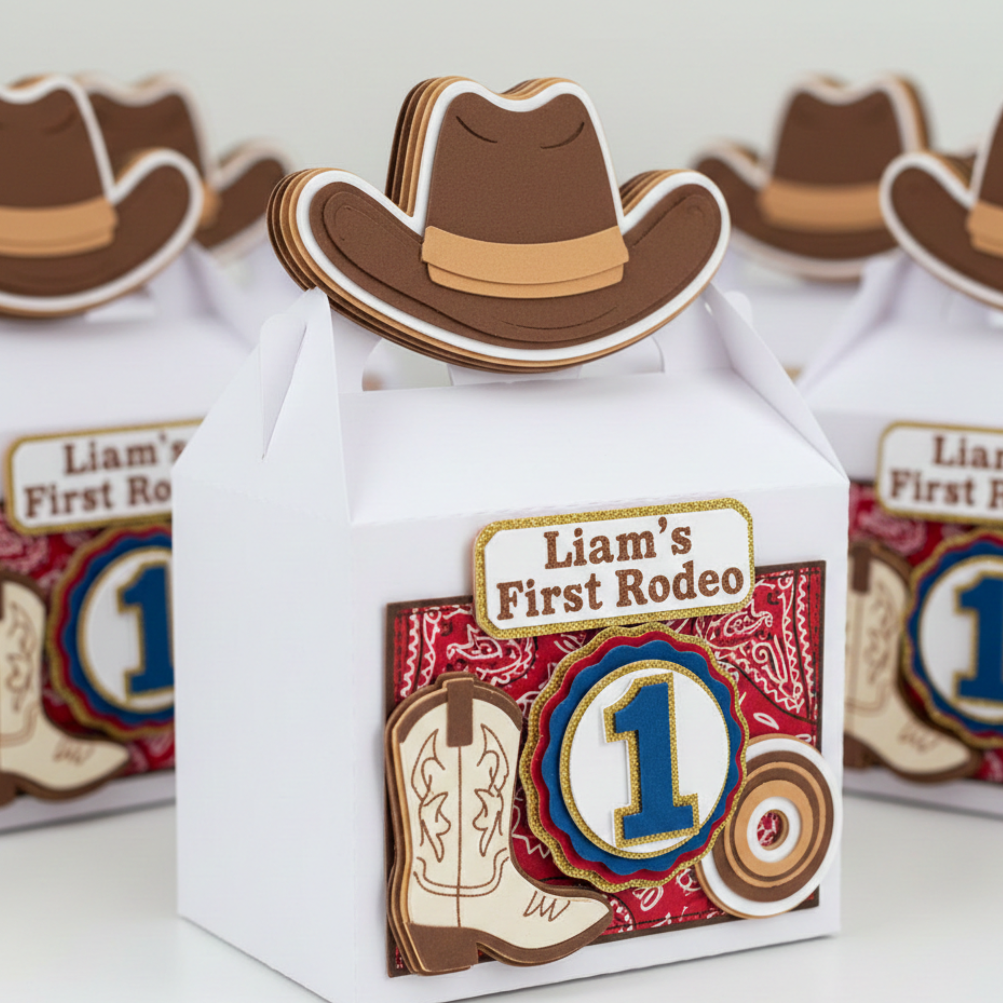 Gift box with cowboy hat design and 'Liam's First Rodeo' text on a white background