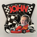 Children's birthday party decoration with a red car, checkered pattern, and 'JOHN 5' text.