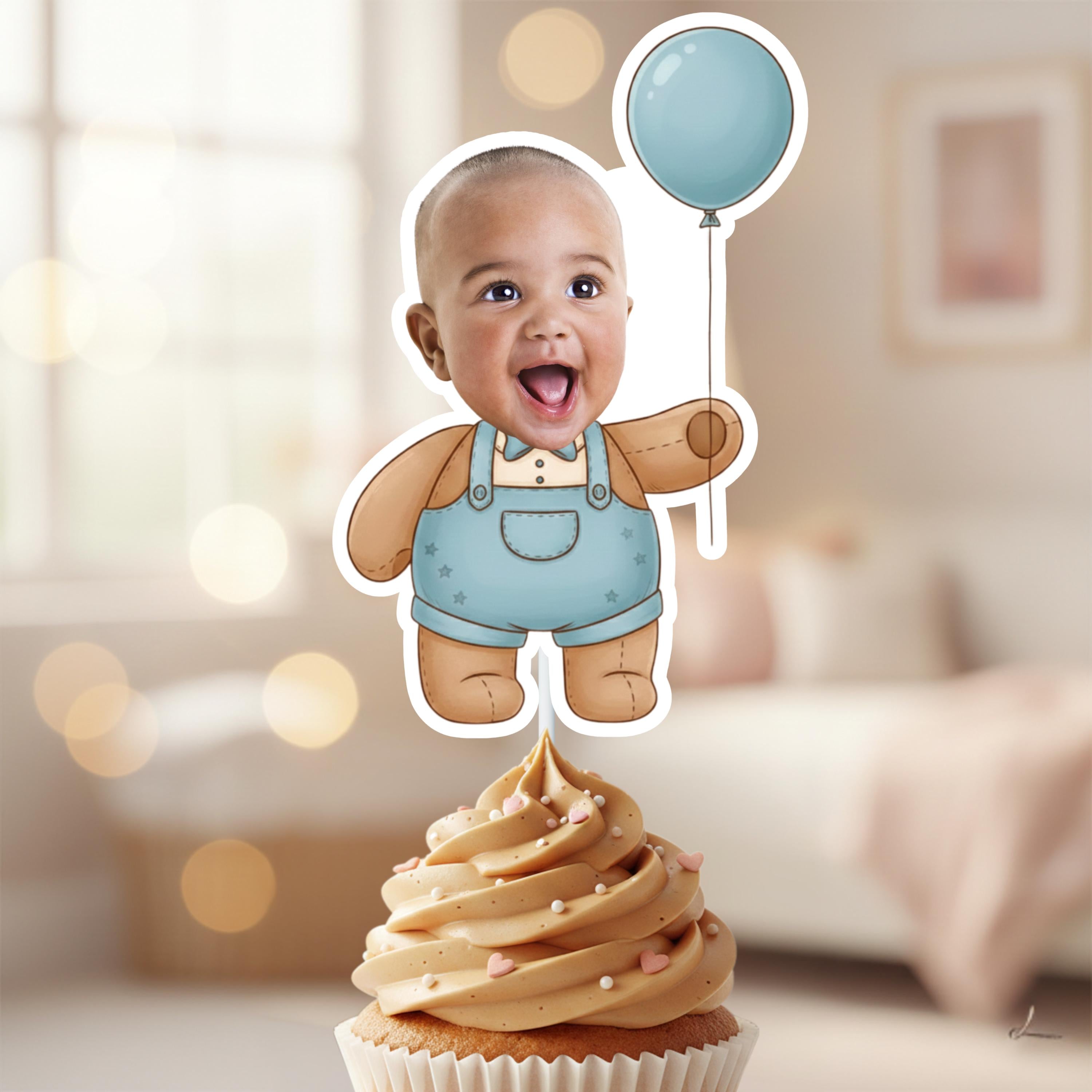 Cupcake with a baby-themed topper featuring a child holding a balloon in a blurred indoor setting.