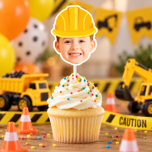 Close up of a personalized construction photo cupcake topper featuring a childs face with a yellow hard hat on a white cake pop stick for a construction birthday party