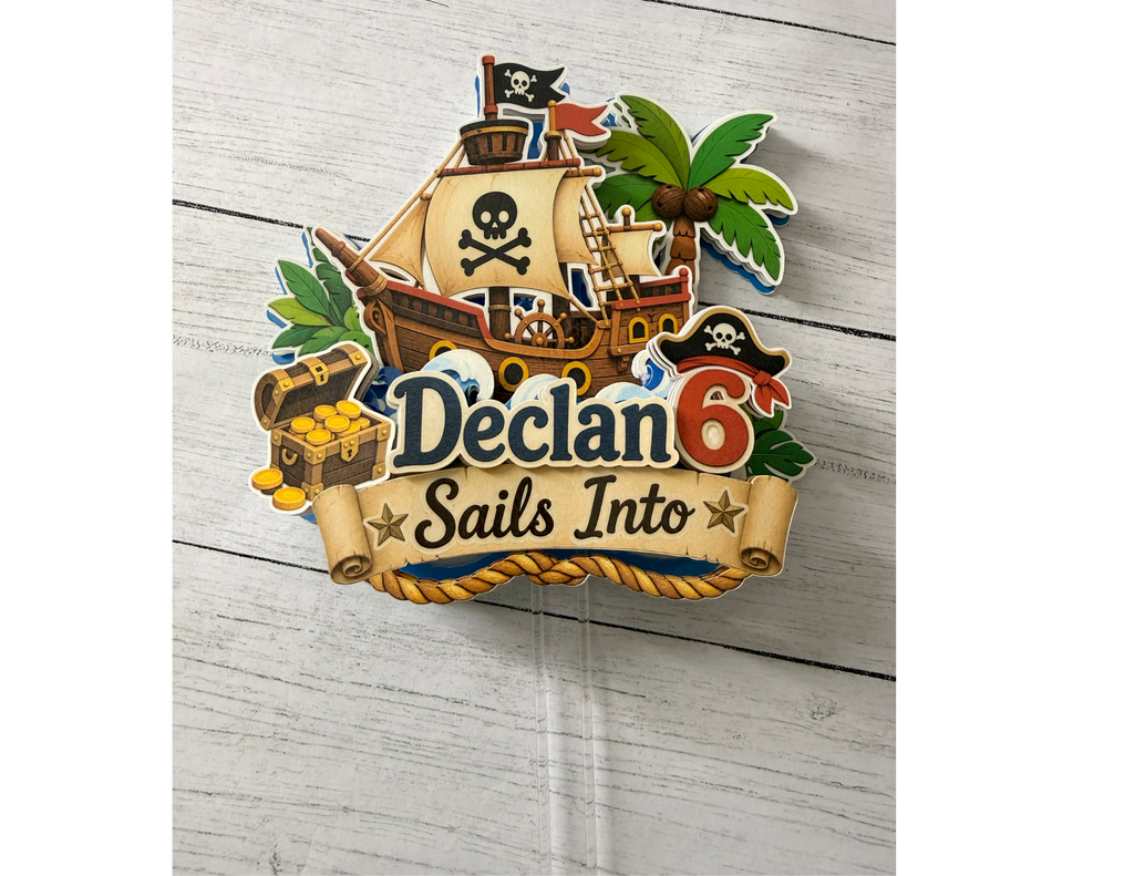 Full view of personalized pirate birthday cake topper with layered pirate ship treasure chest palm tree custom name age and clear cake picks.