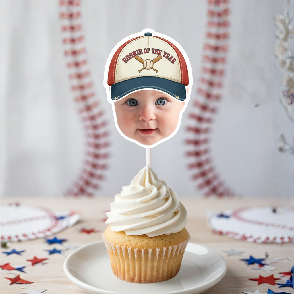 Personalized Rookie of the Year baseball face cupcake topper featuring a baby photo wearing a vintage baseball hat on a vanilla cupcake with baseball stitch backdrop, perfect for first birthday baseball party decorations and sports themed smash cake celebration.
