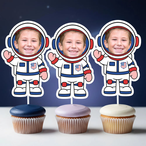 Three cupcakes with astronaut toppers on a dark blue background