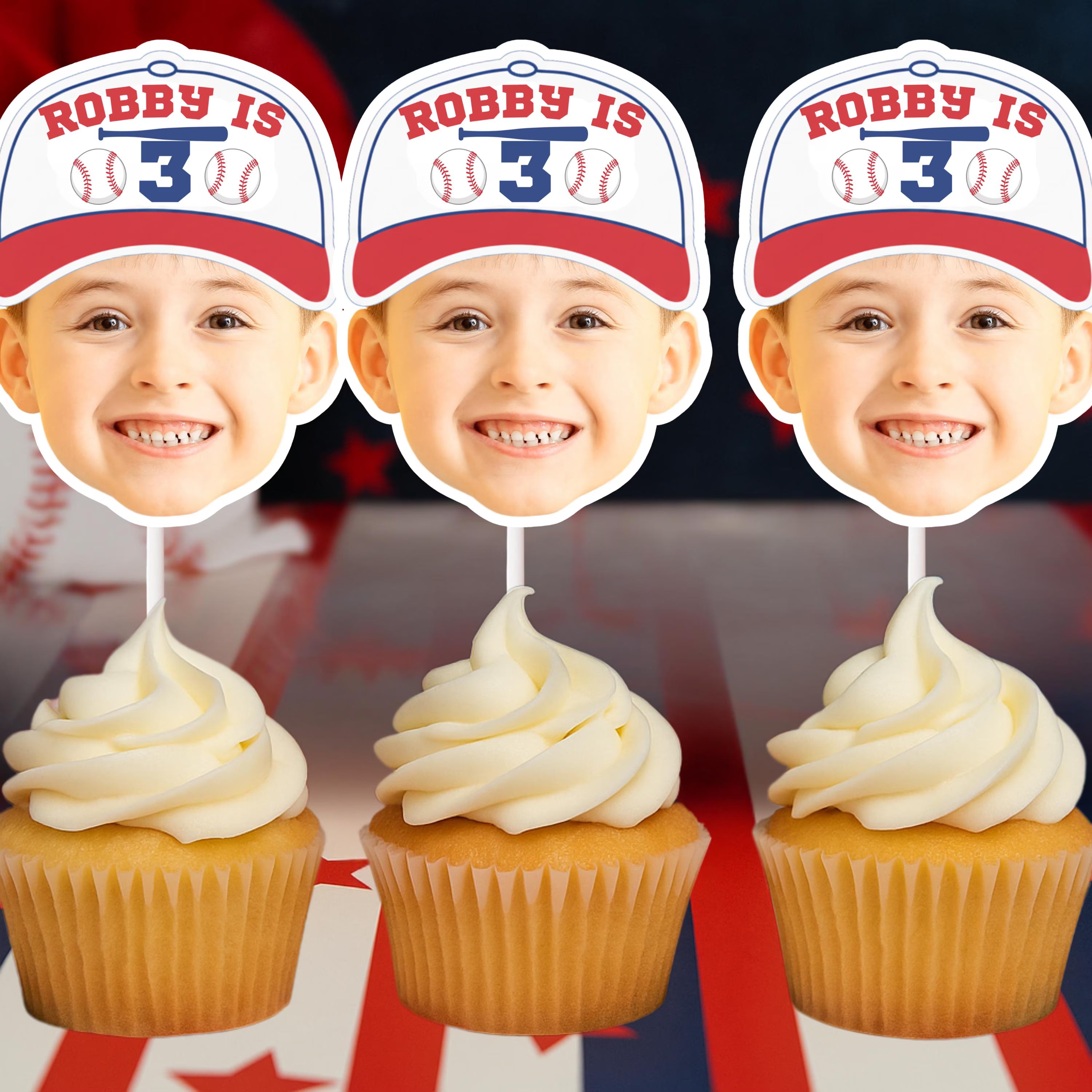 Three cupcakes with white frosting and a baseball-themed topper with 'Robby is 3' text.