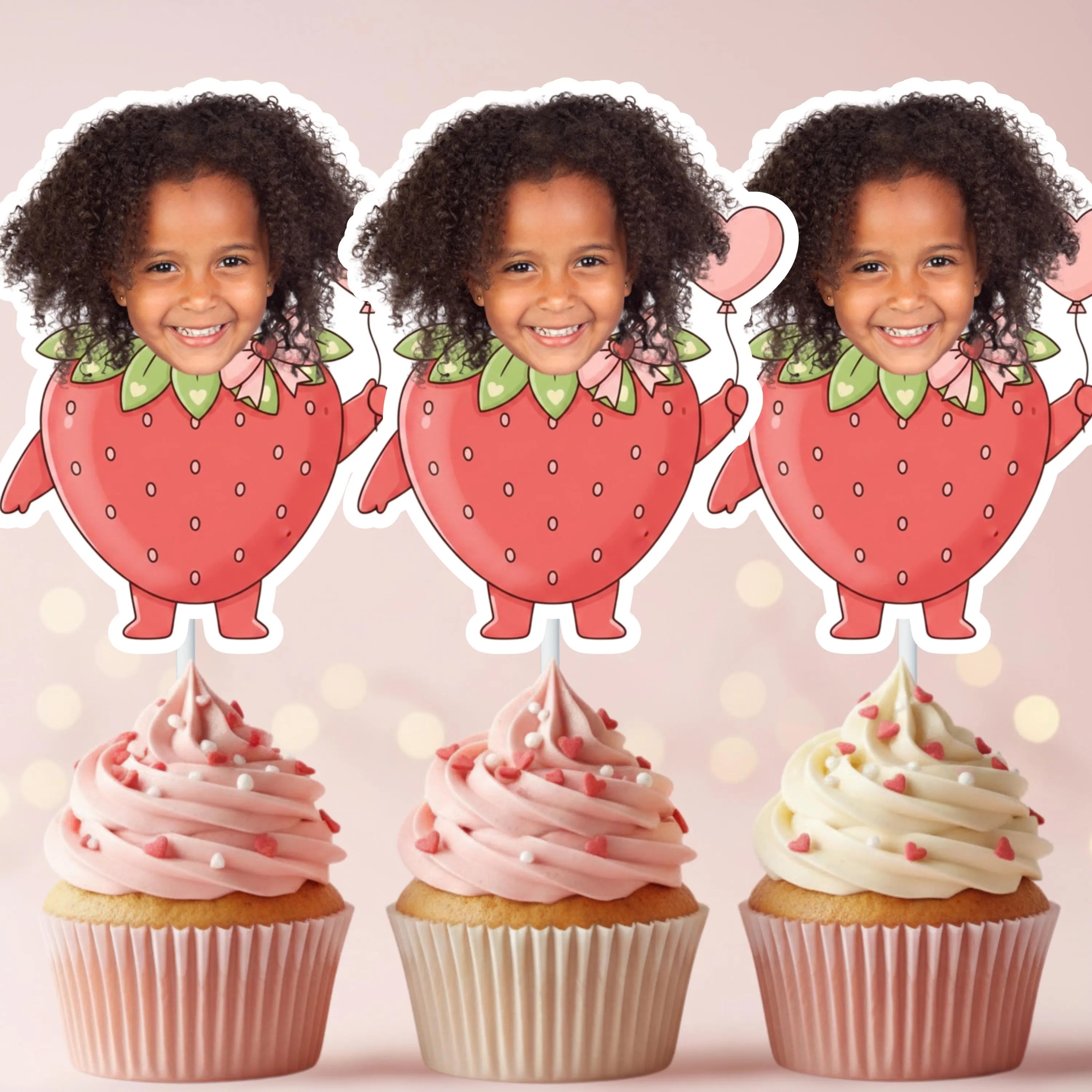 Close up of personalized fruit-themed cupcake toppers with strawberries and small white flower accents for a summer party.