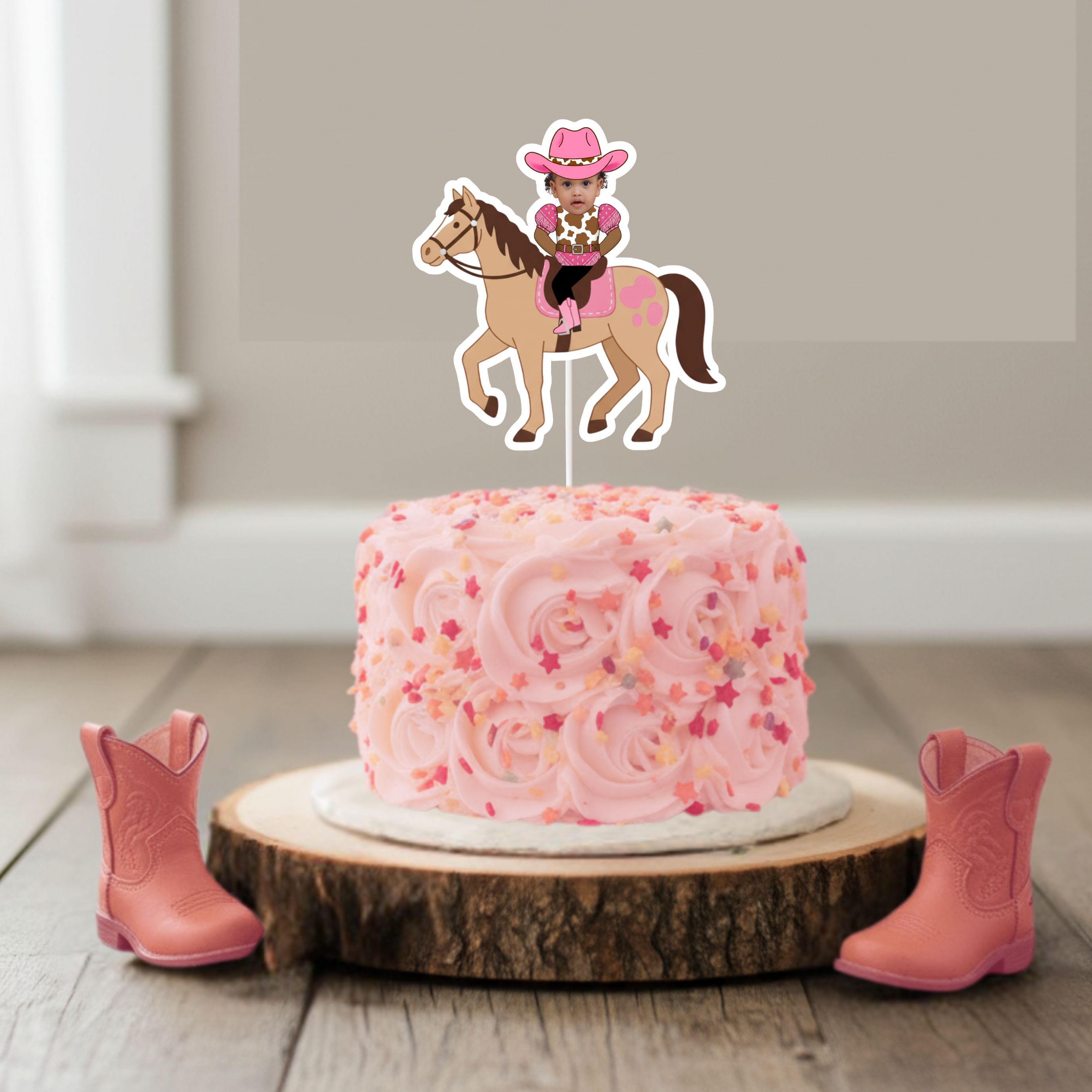 Personalized pink cowgirl horse smash cake topper featuring a baby photo riding a western pony with pink saddle details, displayed on a blush buttercream smash cake with rustic wooden cake stand and pink cowboy boots. This custom “My First Rodeo” cake topper is perfect for cowgirl first birthday parties, western baby girl celebrations, country rodeo birthday themes, and pink barnyard milestone décor. Designed for smash cake photos, dessert table centerpieces, and coordinated western birthday decorations.