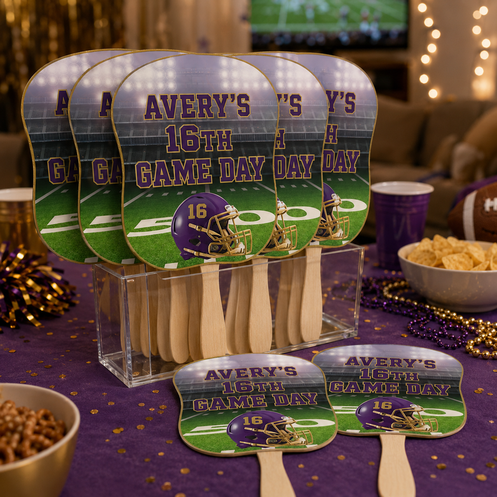 Purple and gold personalized football rally fans for Averys 16th game day birthday party displayed with football decorations and snacks