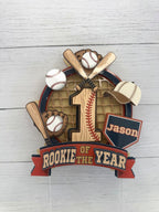 Front view of personalized Rookie of the Year baseball first birthday cake topper with Jason name plate, age 1 and layered baseball details