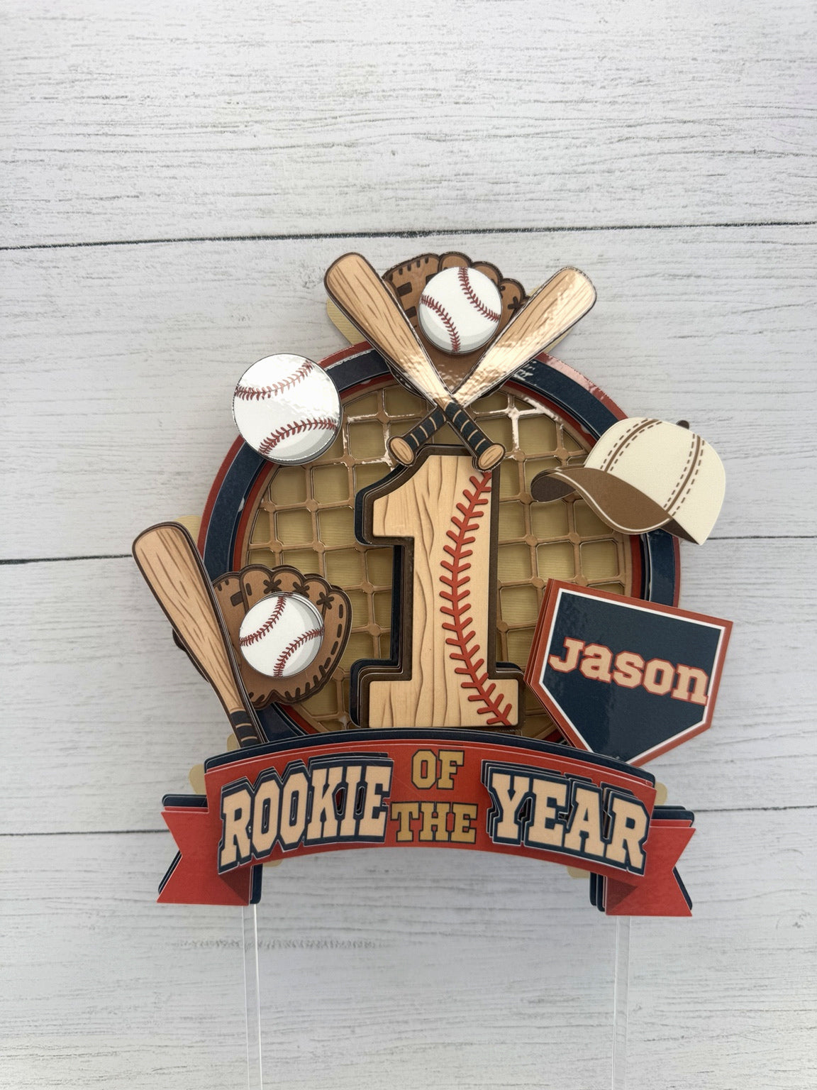 Front view of personalized Rookie of the Year baseball first birthday cake topper with Jason name plate, age 1 and layered baseball details