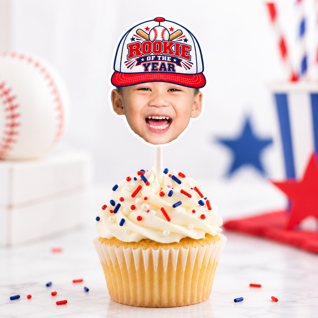Matching personalized Rookie of the Year baseball photo banner and cupcake toppers displayed at a red white and blue baseball birthday party